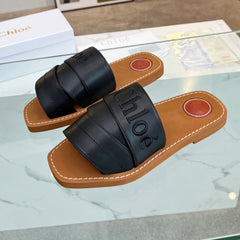 WOODY MULE IN BLACK LAMBSKIN WITH EMBROIDERED LOGO