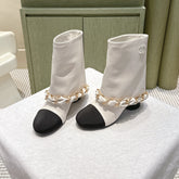 CHANEL 25S CALF-LENGTH BOOTS 45MM IN WHITE AND BLACK CALFSKIN GOLD HARDWARE