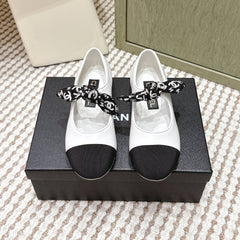 CHANEL 25S MARY JANES IN WHITE AND BLACK SHEARLING AND GROS GRAIN