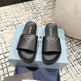 PRADA 25S RUBBER SLIDE IN BLACK CALFSKIN WITH LOGO