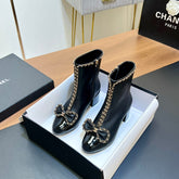 CHANEL 25S HEELED CHAIN BOOTS WITH BOW IN BLACK CALFSKIN GOLD HARDWRE