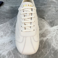 PRADA 25S MONTECARLO ANTIQUED SNEAKERS IN CHALK WHITE NAPPA LEATHER
