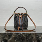 CLARA BAG 19 IN BLACK TRIOMPHE CANVAS AND BROWN CALFSKIN TRIM