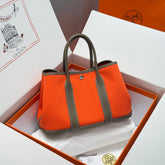 GARDEN PARTY 30CM IN ORANGE MINIMUM TOILETS COTTON CANVAS AND BROWN CALFSKIN