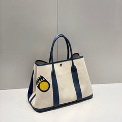 GARDEN PARTY 36 IN NAVY CREAM TOILE H CANVAS BLUE MARINE CALFSKIN ABSTRACT BEAR FACE PRINT