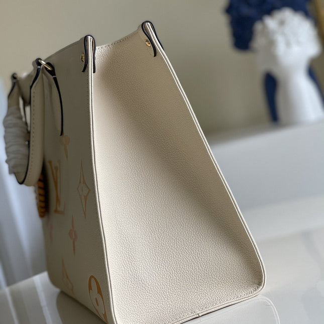 LV ONTHEGO MM 35 CREAM COWHIDE-LEATHER TRIM