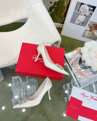 EFFLORESCENCE POINTED-TOE PUMPS IN WHITE SATIN WITH CRYSTAL BUCKLE