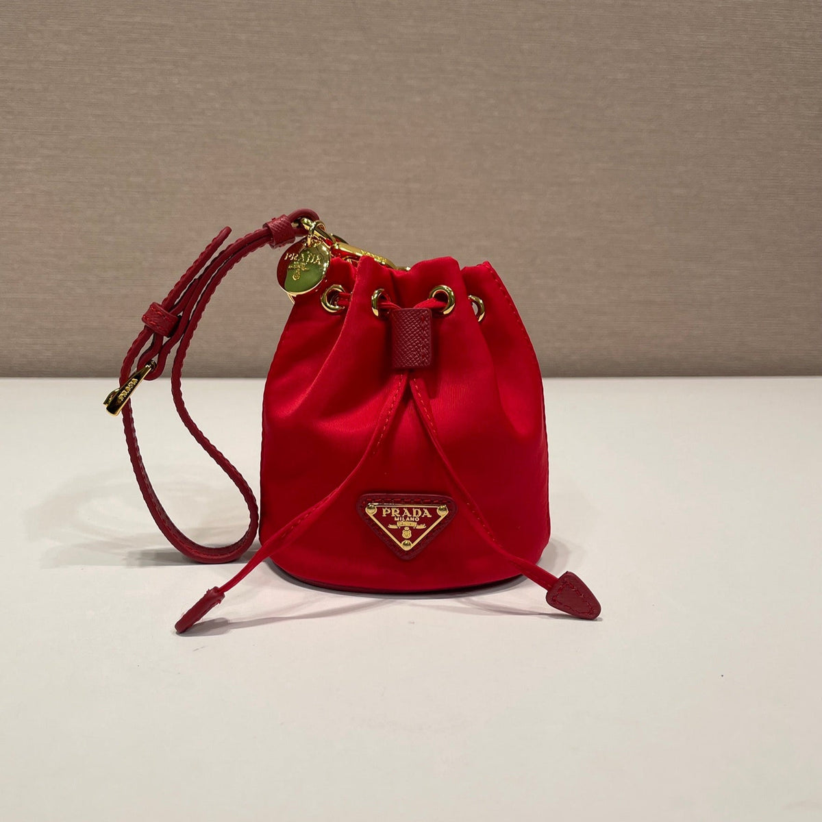 MINI BUCKET BAG 10 IN RED RE-NYLON AND SAFFIANO LEATHER STRAP