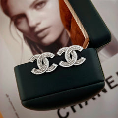 DOUBLE C STUD EARRINGS WITH WHITE TRIM AND CLEAR STONE LOGO