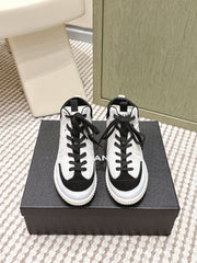 CHANEL 25S HIGH-TOP SNEAKERS IN BLACK AND WHITE CALFSKIN AND SUEDE