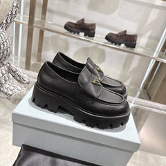 PRADA 25S THICK-SOLE LOAFERS 60 MM IN BLACK SMOOTH CALFSKIN