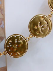 TWISTED CHAIN BELT WITH RHINESTONES AND LOGO PLATE IN GOLD TONE